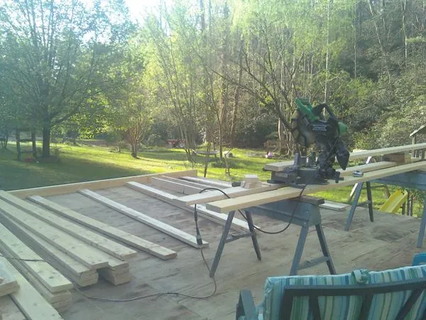 Miter saw and framing lumber on a deck under construction in Sadieville
